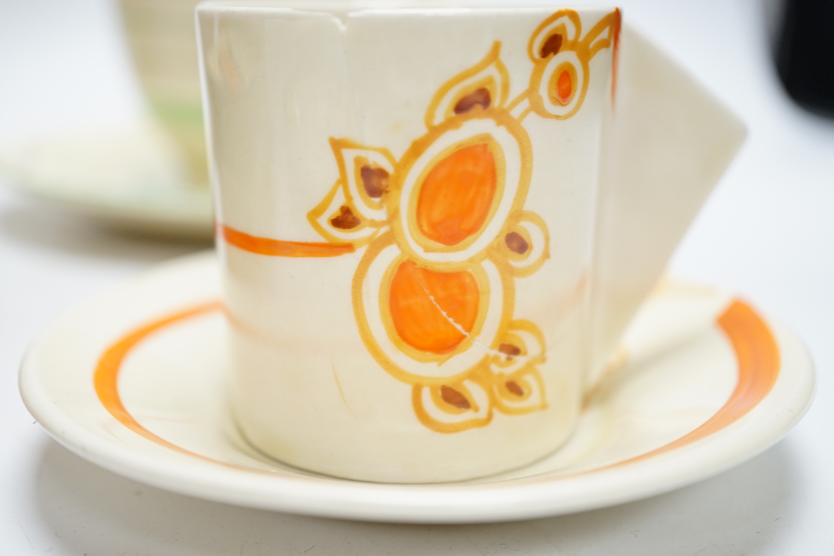 A Clarice Cliff Fantasque butter dish and cover, a Bizarre pot and five other Clarice Cliff items, tallest 20.5cm high